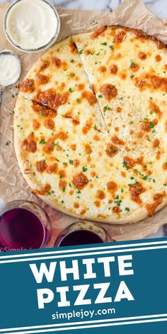 a white pizza sitting on top of a table next to sauces and condiments