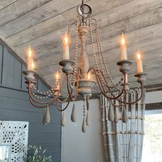 a chandelier hanging from the ceiling in a room