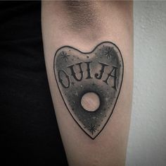 a heart shaped tattoo with the word ouja on it's left side arm