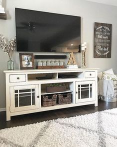 a white entertainment center in a living room