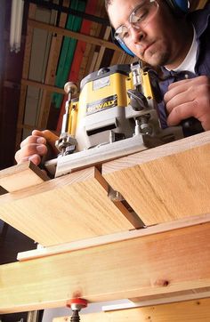 a man using a power drill to attach a piece of wood