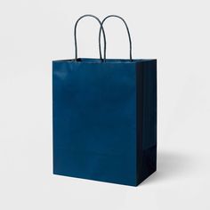 a blue shopping bag with two handles on the front and side, against a white background