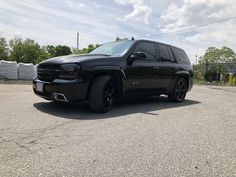 a black truck is parked on the street