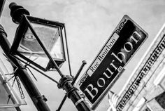 a black and white photo of a street sign on the corner of bourron