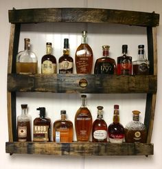 an old wooden shelf filled with liquor bottles