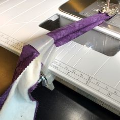 the sewing machine is being used to sew fabric on it's sides,