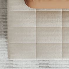 an overhead view of a bed with white sheets and pillows