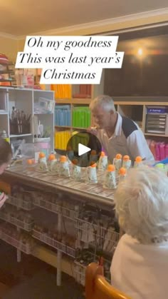 an older man and woman are looking at bottles on a table in front of them