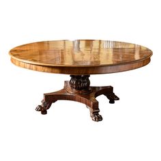 an oval wooden table with carved legs