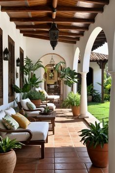 an outdoor covered patio with seating and potted plants