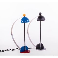 two different colored lamps sitting next to each other