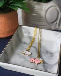 Add a touch of adorableness to your outfit with our Paisley Necklace featuring a gold chain and a handmade enamel lamb pendant. Available in 14 or 16 inch lengths. Perfect for animal lovers (ba-a-a-dly). Style A: white lamb, 14 inch length Style B: pink lamb, 16 inch length Pink Heart Print Necklace For Gift, Brass Heart Charm Medallion Necklace, Paisley Necklace, Lamb Necklace, Rabbit Pendant Necklace, Rabbit Necklace, Animal Lovers, Necklace Gold, Gold Chain