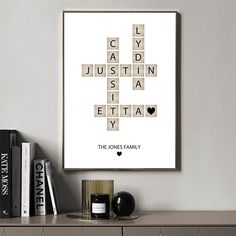 a crossword puzzle print on a wall above a book shelf with books and candles