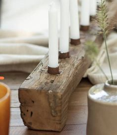 candles are lined up on a table with the words trouva in front of them