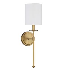 a wall light with a white shade on the side and a metal pole attached to it