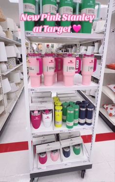 there is a display in the store with pink and green items on it's shelves