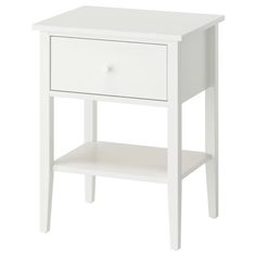 a white night stand with two drawers on one side and an open drawer on the other