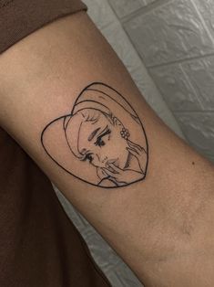 a woman's arm with a drawing of a girl in a hat on it