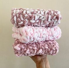 three pink and white towels stacked on top of each other