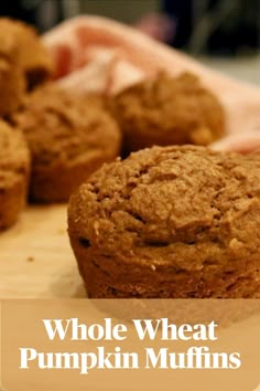 whole wheat pumpkin muffins on a cutting board with the words, whole wheat pumpkin muffins