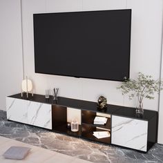 an entertainment center with a large flat screen tv mounted on the wall and marbled flooring