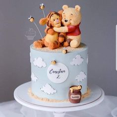 a winnie the pooh birthday cake is decorated with frosting and fondant decorations