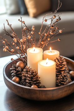 Fall coffee table decor with a wooden bowl centerpiece of lit candles, pinecones, and decorative branches. Cozy seasonal coffee table decor ideas. Fall To Winter Decor Transition, Decorating Bowls Ideas, Neutral Brown Christmas Decor, Decorating With Bowls, Christmas Interior Decor Ideas, Christmas Bowl Decor, Table Decorations Round Tables, Christmas Table Decor Diy, Christmas Coffee Table Ideas