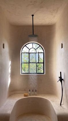 a bath room with a large tub and a window