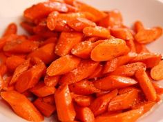 sliced carrots in a white bowl on a table