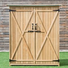 a large wooden storage shed with two doors