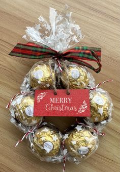 christmas chocolates wrapped in cellophane and tied with ribbon on wooden table top