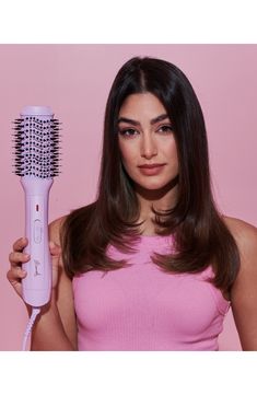 What it is: A tool that combines the power of a hair dryer with the structure of a round brush to cut your beauty prep time in half. What it does: Getting ready each morning has never been easier with this blow-dryer brush to dry and style your hair and give you a salon-quality finish that'll be the envy of everyone. It features a unique oval brush, tangle-free bristles and ionic technology for extra shine and follicle protection, so its suitable for all hair types and lengths. Its also super lightweight. You can bid sore arm goodbye and enjoy your killer blowout even on the next day. How to use: For a sleek blow dry, start with clean, towel-dried hair and apply a heat-protectant. Brush out your hair using a detangling comb or a brush and separate into large sections. Taking one section at Hair Blow Dryer Brush, Rotating Hair Dryer, Blow Dryer Brush, Detangling Comb, Hair Blow Dryer, Dryer Brush, Oval Brush, Blow Dry Brush, Heat Protectant