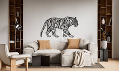 a living room filled with furniture and a tiger wall decal