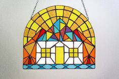 a stained glass window hanging from a chain