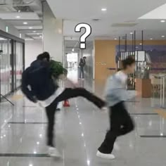 two young men are dancing in the middle of an empty mall floor, one is wearing a backpack