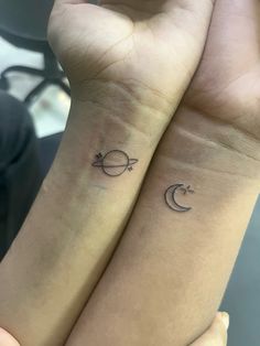 two small wrist tattoos with crescents and stars on each side of their wrists,