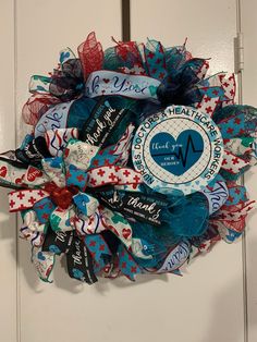 a wreath that is hanging on the door with some ribbon around it and an i love my heart patch