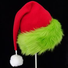 "This festive Santa hat is made up in a red fleece fabric and features an accent brim of lush bright green fur trim, close match to a Grinch green. The red fabric is a soft quality poly fleece fabric, cozy and warm. Proportions of the hat are generous and will fit most head sizes, ladies or gents. The styling is a slouch cone, traditional Santa look. Measurement for opening for your head is 24- 25\" circumference and the length is 20\". There is a white faux fur pompom dangle on the hat." Green Brimmed Winter Costume Hats, Green Winter Costume Hats And Headpieces, Kids Santa Hat, Grinch Hat, Christmas Party Hat, Christmas Party Hats, Green Santa, Green Fur, Red Green Christmas