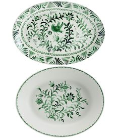 two green and white plates sitting side by side on top of each other, one with an image of a bird in the center