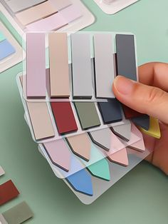 a person is holding some color swatches in their hand and the colors are all on top of each other