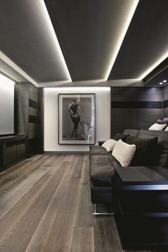 a living room filled with furniture and a flat screen tv on top of a wooden floor