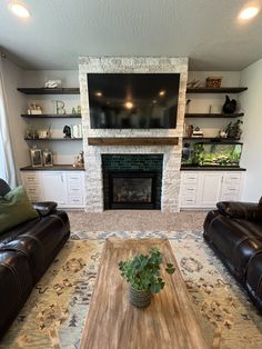 a living room with two couches and a fireplace