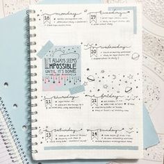 a spiral notebook is open on top of some papers with writing and numbers in it