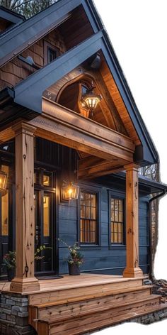 a wooden porch with two lights on the front and side of it, next to a blue house