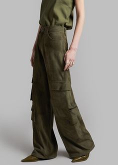 Color: Olive Midweight suede fabric Oversized cargo style Enlarged cargo pockets at each leg Slant hip pockets Back patch pockets Adjustable drawcords at hem Zip fly Front button closure Unlined 100% Goat Leather Dry Clean by Leather Specialist By The Frankie Shop. Imported Oversized Cargo Pants, Classic Trousers, The Frankie Shop, Frankie Shop, Cargo Style, Mini Short, Suede Fabric, Goat Leather, Wide Leg Denim