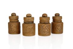 four wooden salt and pepper shakers on a white surface