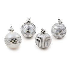 four silver and white ornaments on a white background