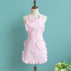 a mannequin wearing a pink apron with ruffles on the front and back