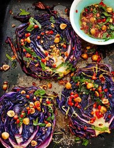 cabbage and chickpeas on a baking sheet with a bowl of dressing next to it