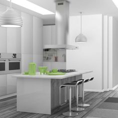 a kitchen with white cabinets and green counter tops on the island in front of two stools